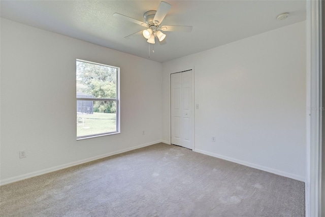 carpeted empty room featuring ceiling fan