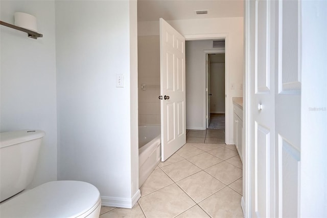 bathroom featuring a tub to relax in, tile patterned flooring, vanity, and toilet