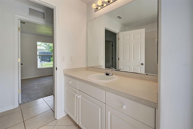 bathroom featuring tile patterned flooring and vanity