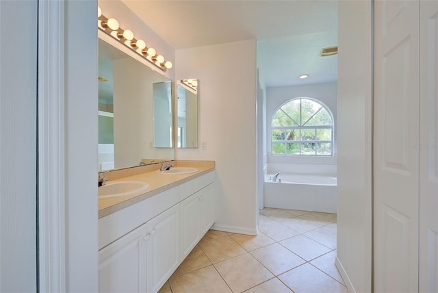 bathroom featuring vanity, a bathing tub, and tile patterned flooring