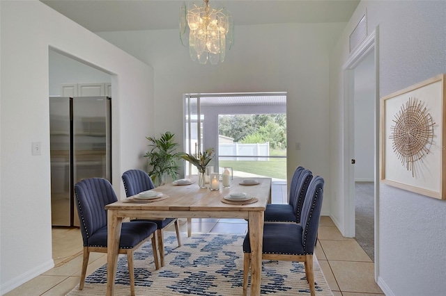 tiled dining room with a chandelier