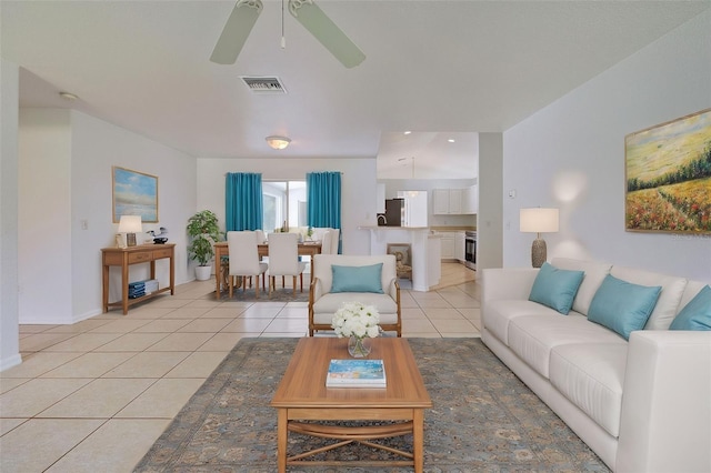 tiled living room featuring ceiling fan