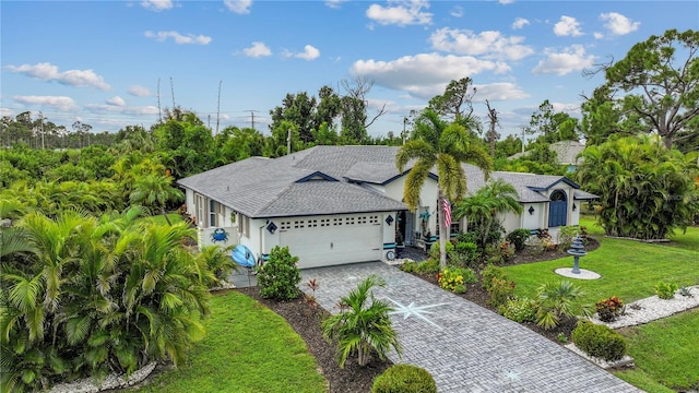 view of front of house featuring a front lawn and a garage