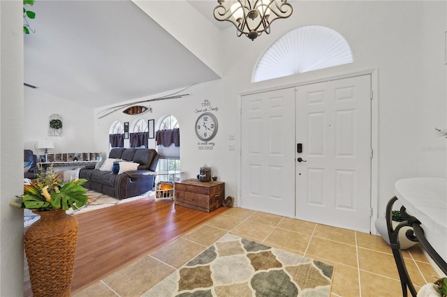 foyer featuring a notable chandelier, hardwood / wood-style flooring, and a healthy amount of sunlight