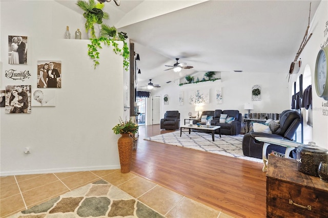 living room featuring lofted ceiling, hardwood / wood-style floors, and ceiling fan