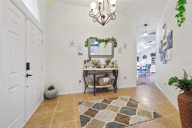 foyer featuring vaulted ceiling, an inviting chandelier, and tile patterned flooring