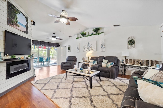 living room with vaulted ceiling, hardwood / wood-style flooring, and ceiling fan