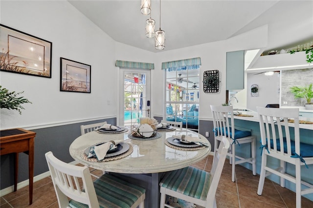 tiled dining area with vaulted ceiling