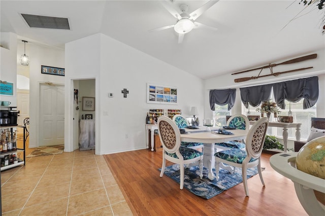 dining space featuring ceiling fan, hardwood / wood-style floors, and high vaulted ceiling