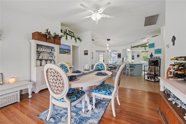 dining room featuring lofted ceiling, ceiling fan, and light hardwood / wood-style floors