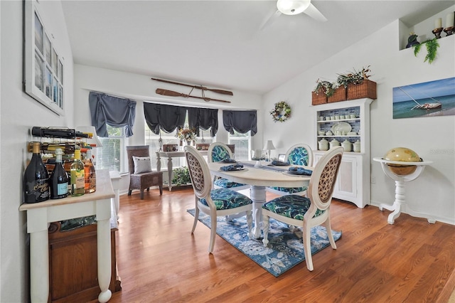 dining area with wood-type flooring and ceiling fan