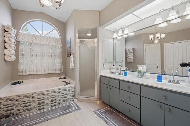 bathroom featuring lofted ceiling, vanity, an inviting chandelier, and plus walk in shower