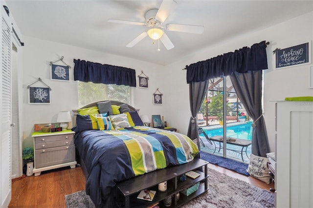 bedroom with ceiling fan, dark hardwood / wood-style flooring, and access to outside