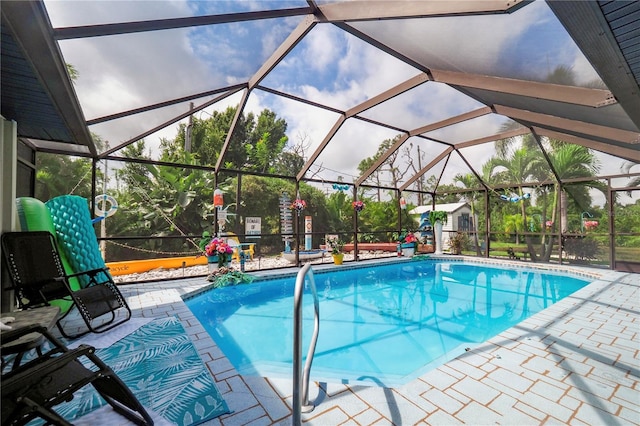 view of swimming pool with glass enclosure and a patio