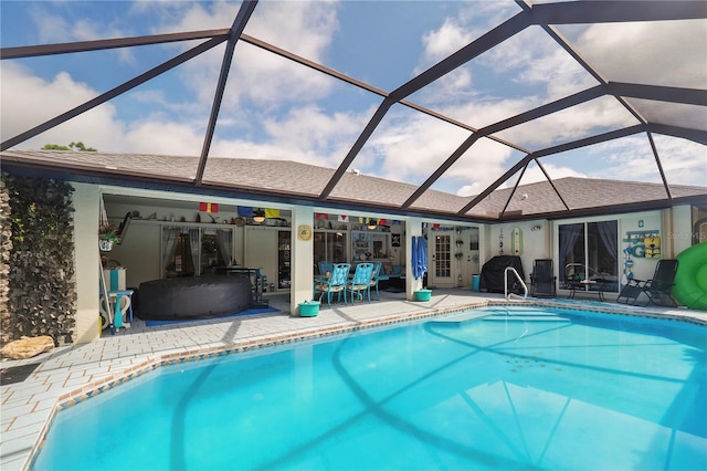 view of pool with a lanai and a patio area