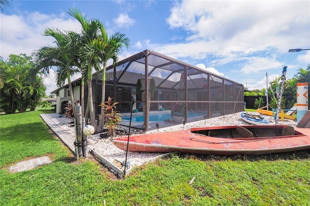 exterior space with glass enclosure and a lawn