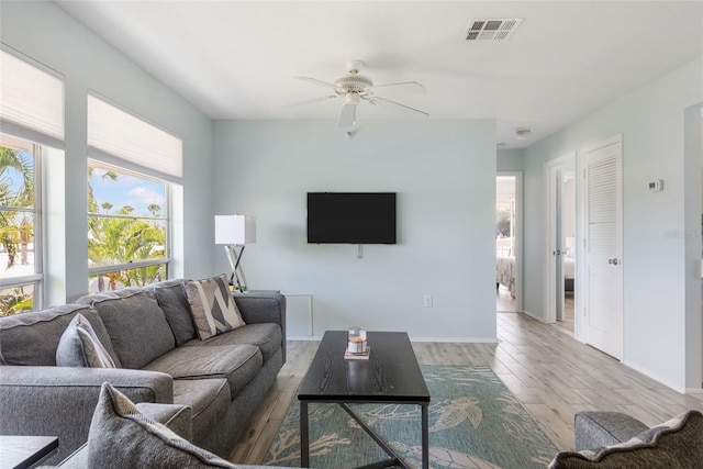 living room with ceiling fan and wood-type flooring