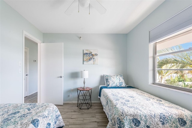 bedroom with light hardwood / wood-style floors and ceiling fan