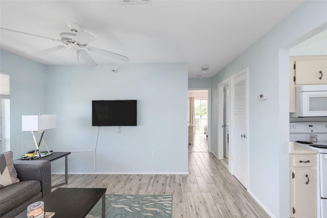 living room featuring light hardwood / wood-style floors and ceiling fan