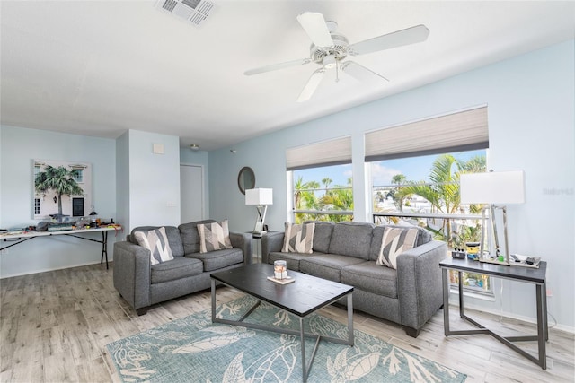 living room with ceiling fan and light wood-type flooring