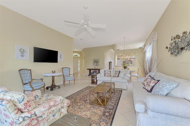 living room featuring ceiling fan with notable chandelier and light tile patterned flooring