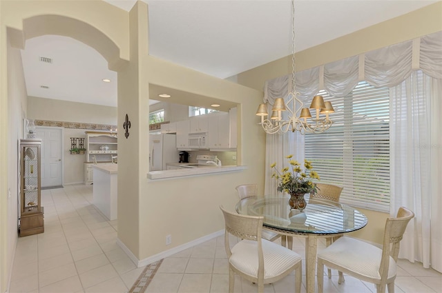 dining room featuring an inviting chandelier and light tile patterned flooring