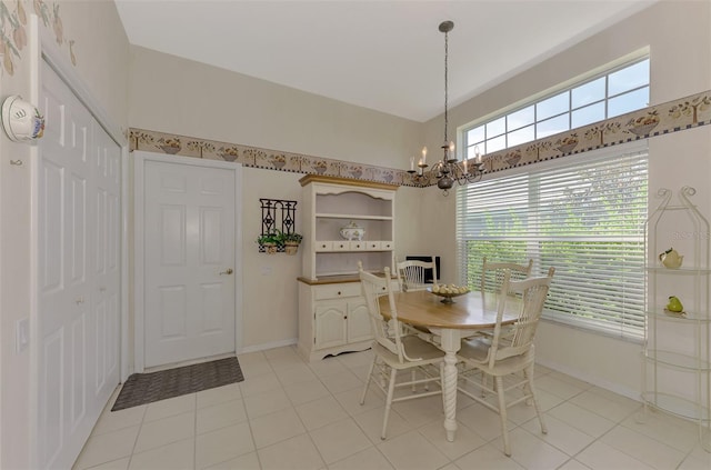 dining area with light tile patterned floors and an inviting chandelier