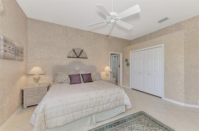 bedroom with a closet, ceiling fan, and light tile patterned floors