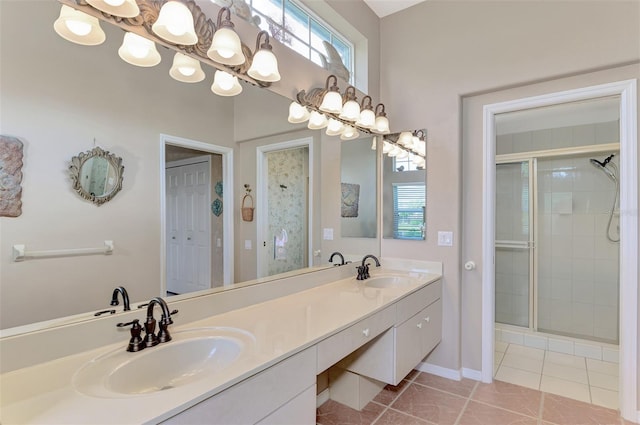 bathroom with tile patterned floors, a shower with shower door, and vanity