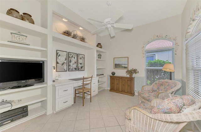 tiled home office with built in shelves, ceiling fan, and built in desk