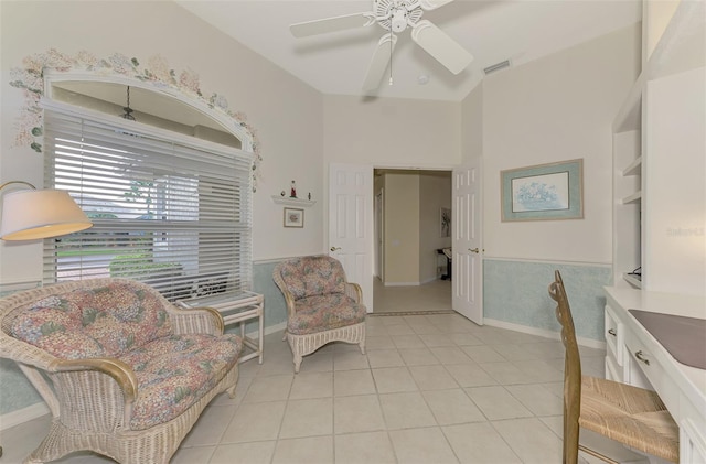 living area with ceiling fan and light tile patterned flooring