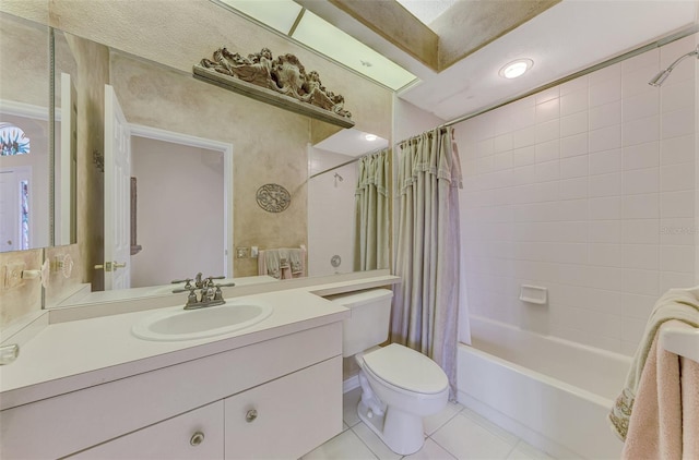 full bathroom featuring shower / bath combo with shower curtain, tile patterned floors, toilet, and vanity