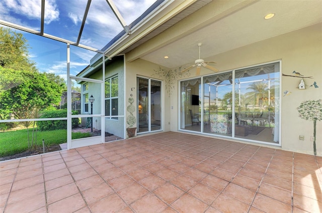 unfurnished sunroom featuring ceiling fan