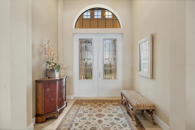 foyer with a high ceiling and french doors