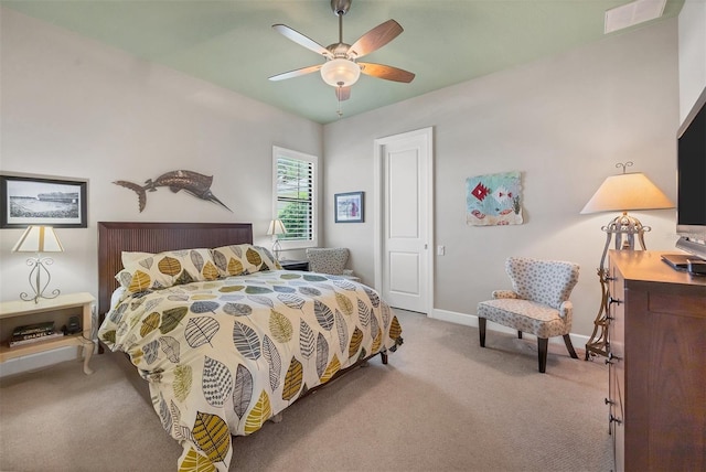 bedroom featuring light carpet and ceiling fan