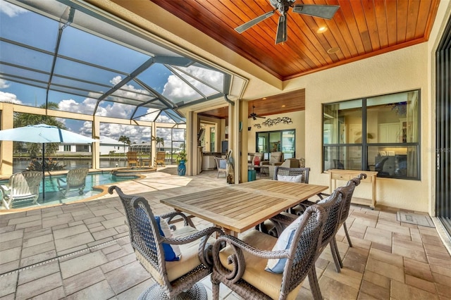 view of patio / terrace featuring a lanai and ceiling fan