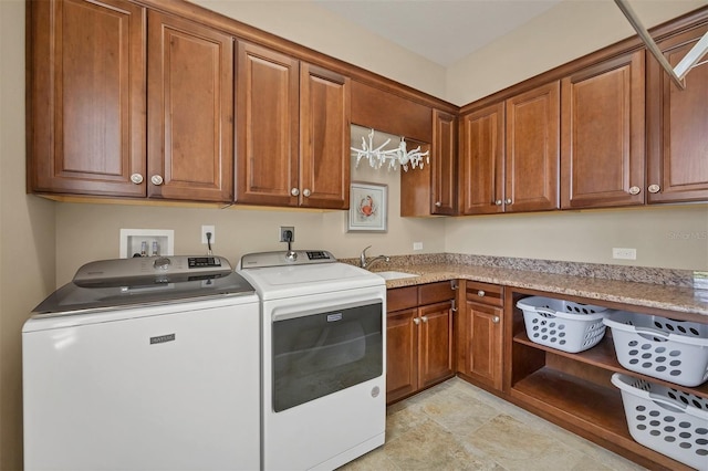 laundry area with cabinets, sink, and washing machine and dryer