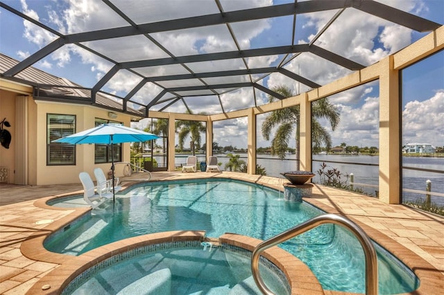 view of swimming pool with a lanai, a patio, an in ground hot tub, and a water view