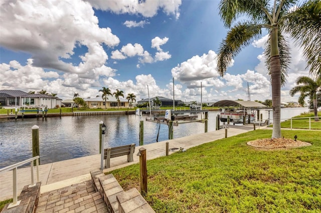 view of dock featuring a water view and a yard