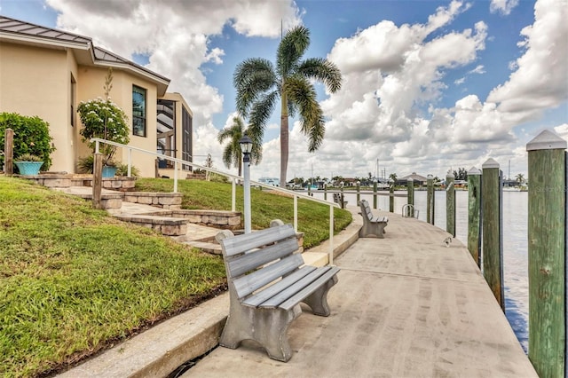 view of property's community featuring a dock and a water view