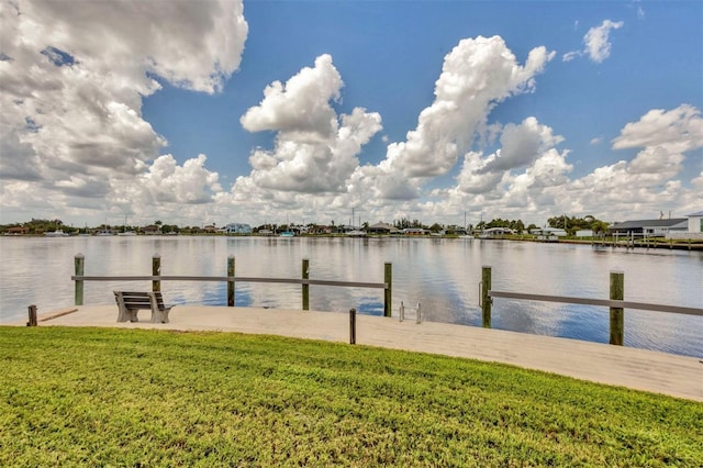 dock area featuring a yard and a water view