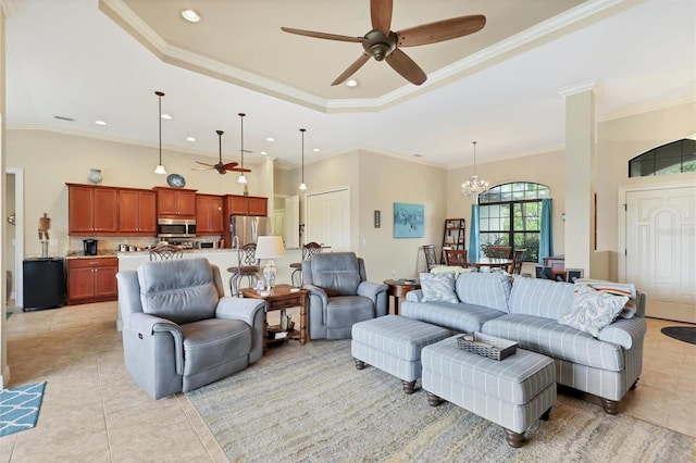 tiled living room featuring a high ceiling, ceiling fan with notable chandelier, a raised ceiling, and crown molding