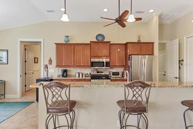 kitchen with stainless steel appliances, light stone counters, backsplash, and ceiling fan