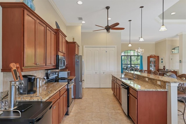 kitchen with ceiling fan with notable chandelier, decorative light fixtures, appliances with stainless steel finishes, a breakfast bar, and sink