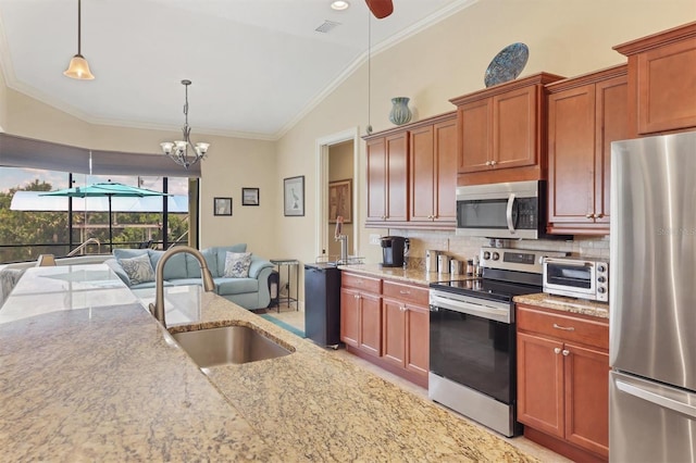 kitchen featuring decorative light fixtures, ceiling fan with notable chandelier, stainless steel appliances, sink, and ornamental molding