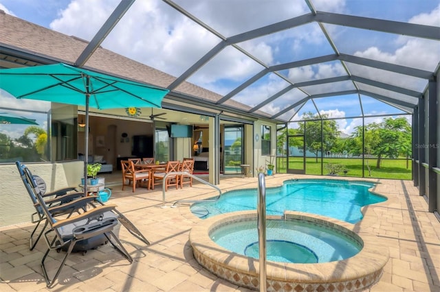 view of swimming pool with glass enclosure, an in ground hot tub, ceiling fan, and a patio