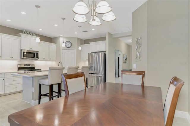 dining room featuring an inviting chandelier and light tile patterned floors