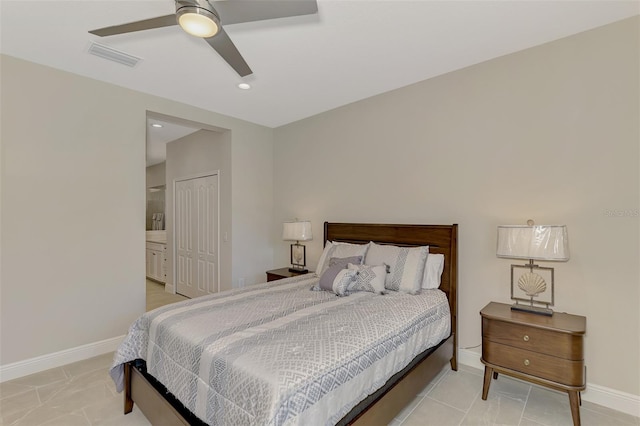 bedroom with ensuite bathroom, ceiling fan, and a closet