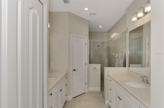 bathroom with vanity and a tile shower