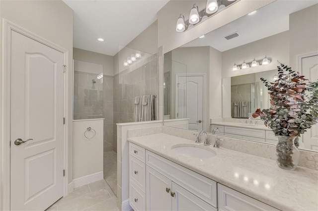 bathroom with vanity and tiled shower